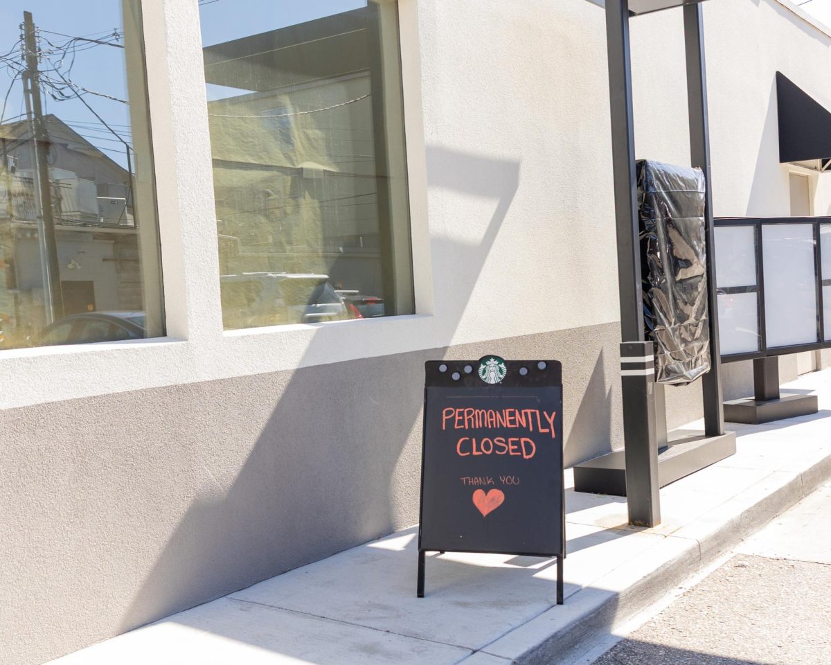 A “Closed Permanently” sign stands by the drive-thru menu at the Bluemont Avenue Starbucks, marking the end of the coffee shop’s operations.